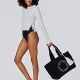 Woman holding the Cabana Beach Bag in Black