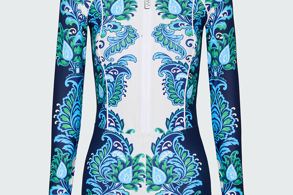 Long-sleeve one piece swimsuit in a blue and green floral pattern on a white background