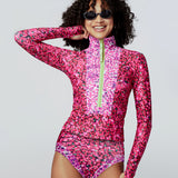 Model in sunglasses wearing Watskin Mia tee and Belle bikini bottom in bright pink Mini Floral