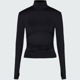 A black long-sleeve mock neck top with ruched detailing at the waist.