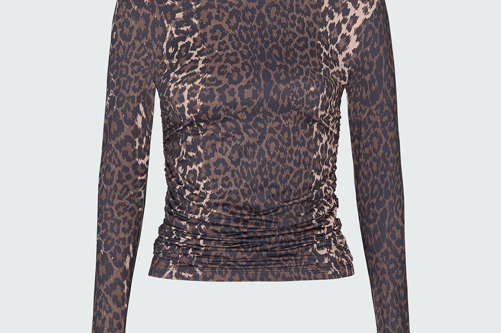 A long-sleeve mock neck rashguard in leopard