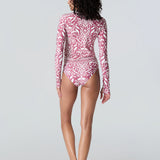 Rear view of woman wearing Watskin rashguard and Belle bikini bottom in Dusty Rose Ikat 