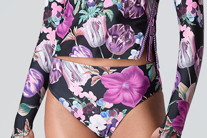Female model wearing Watskin Sasha tee and Belle bikini bottom in Orchid Bloom 