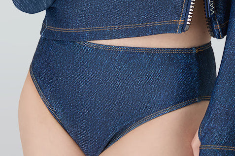 Woman in white sunglasses wearing Watskin rashguard and Belle mid rise bikini bottom in Blue Denim 