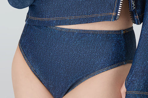 Woman in white sunglasses wearing Watskin rashguard and Belle mid rise bikini bottom in Blue Denim 