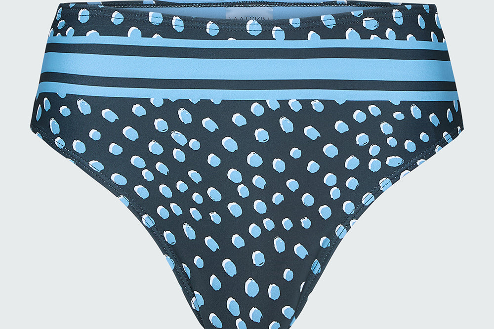 Women's bikini bottom in a blue dot print with placed stripe at waist.
