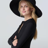 Woman wearing a black sun hat and black bodysuit