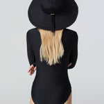 Woman wearing a black sun hat and black bodysuit