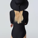 Woman wearing a black sun hat and black bodysuit