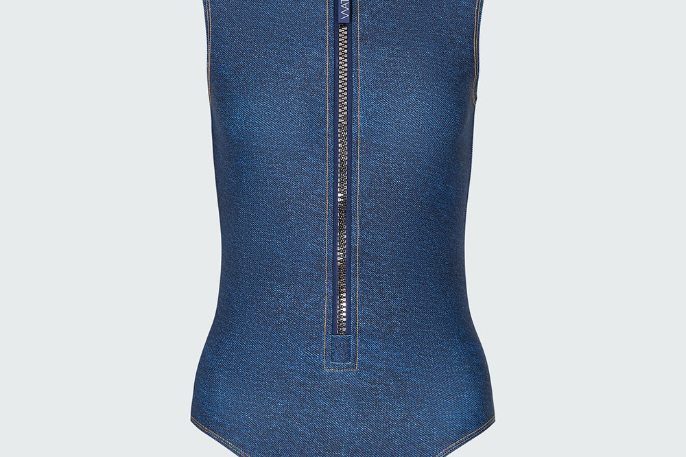 A sleeveless denim bodysuit with a  mock neck and half-zip neckline.