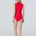 Back view of a woman in a side profile wearing a red sleeveless one-piece swimsuit.