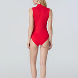 Back view of a woman in a side profile wearing a red sleeveless one-piece swimsuit.