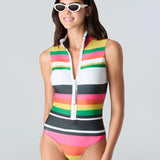 Woman wearing a striped sleeveless swimsuit with white zipper on a gray background
