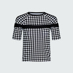 Black and white houndstooth patterned top on a light gray background
