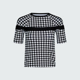 Black and white houndstooth patterned top on a light gray background