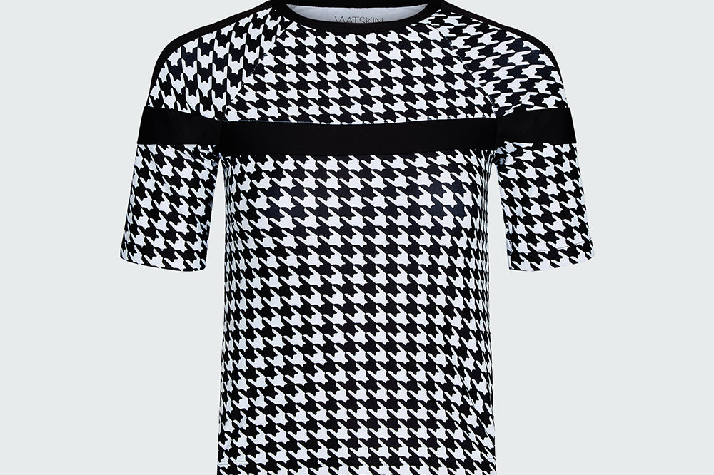 Black and white houndstooth patterned top on a light gray background