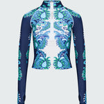 Navy, green and white floral patterned long-sleeve top on a light gray background