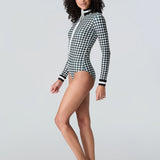Side view of woman wearing Watskin Lilia bodysuit in black/ivory houndstooth 