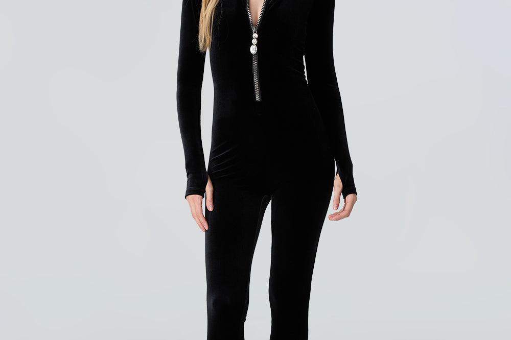 Woman wearing a black full-body Lois cat suit on a white background