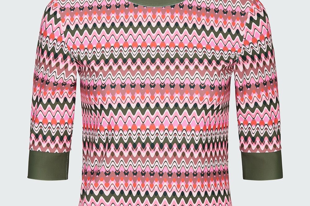 Product flat of a pink and green wavy striped patterned short sleeve swim top with green sleeve cuff