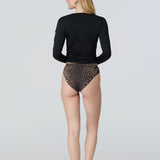 Back view of a woman wearing a black long-sleeve sun protective tee and black bikini bottom