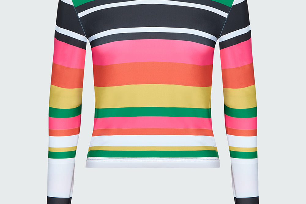 Product image of a brightly colored stripe long sleeve tee with cut outs at thumbs, crew neck, and zipper pocket on bicep of sleeve