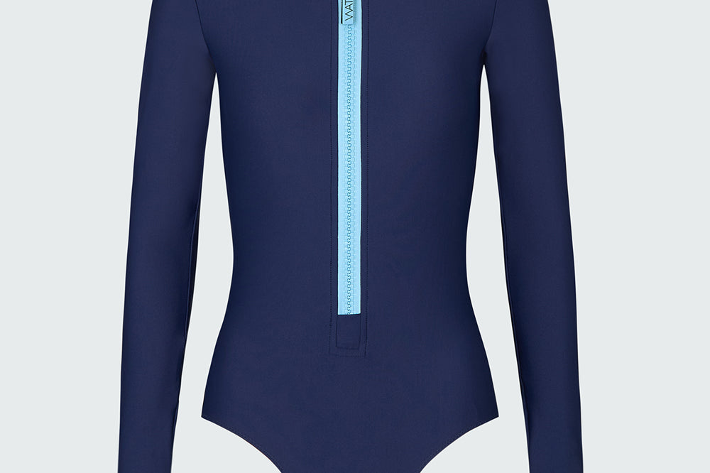 A navy blue long-sleeve bodysuit with a light blue front zipper.