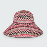 Pink and green wavy striped patterned wide brimmed sun hat on a white background