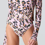 Pink leopard print long sleeve swim top and swim bikini bottom on a gray background