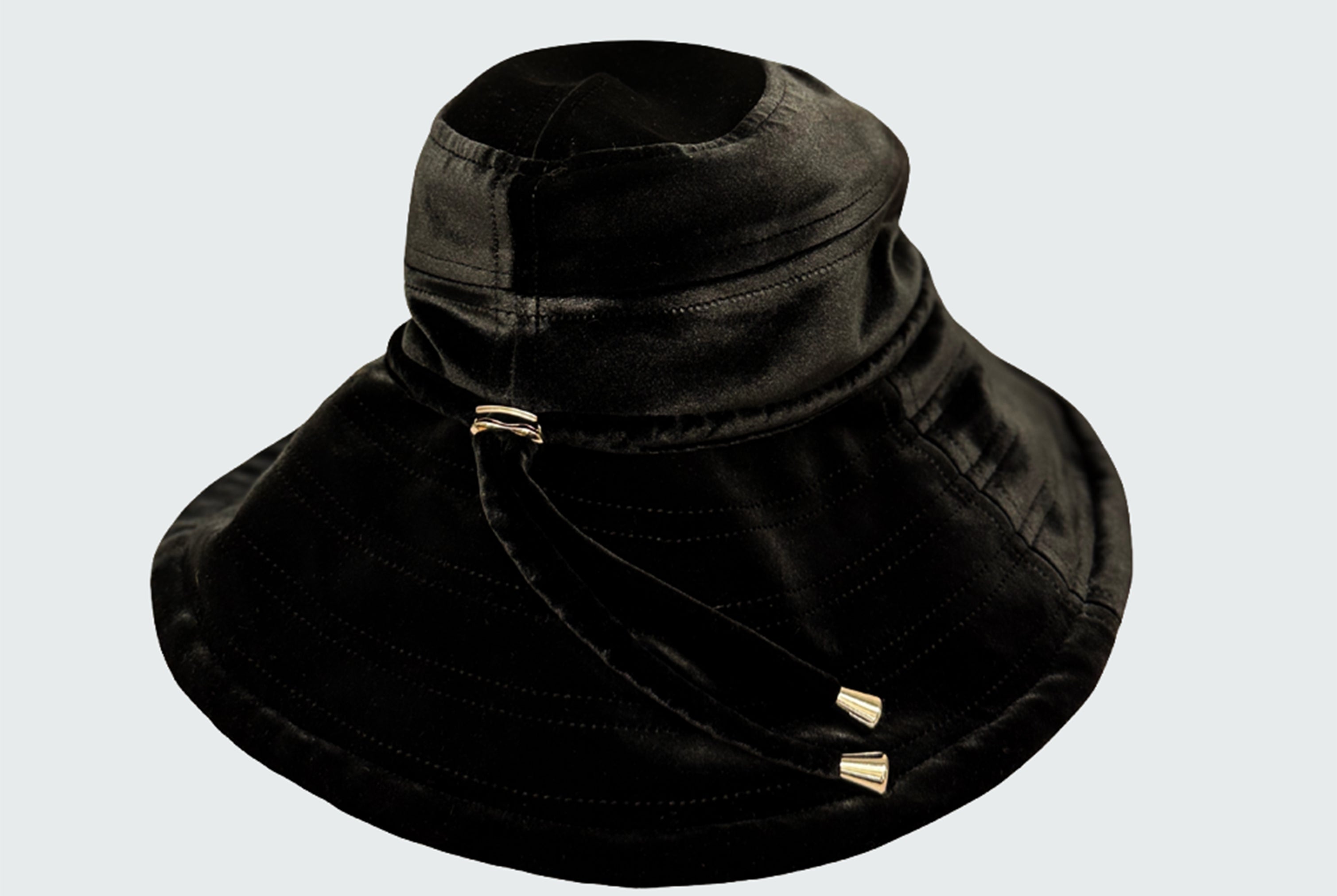 Watskin Sienna black velvet sunhat with cord detailing and gold hardware shown against a light background