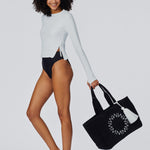 Woman holding the Cabana Beach Bag in Black